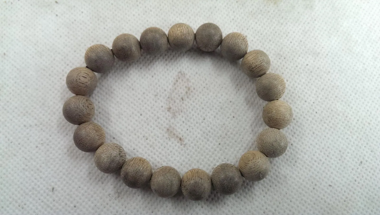 The color of Shenyou's old Cambodian Buddhist prayer beads after being played with and chanted over.