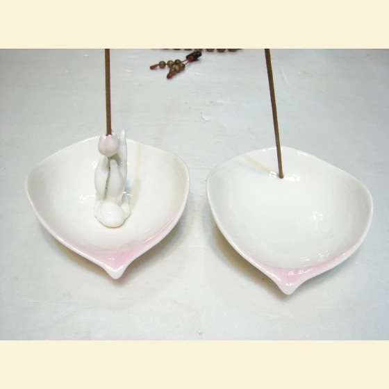 A single leaf reveals the Buddha. Lotus incense holder.