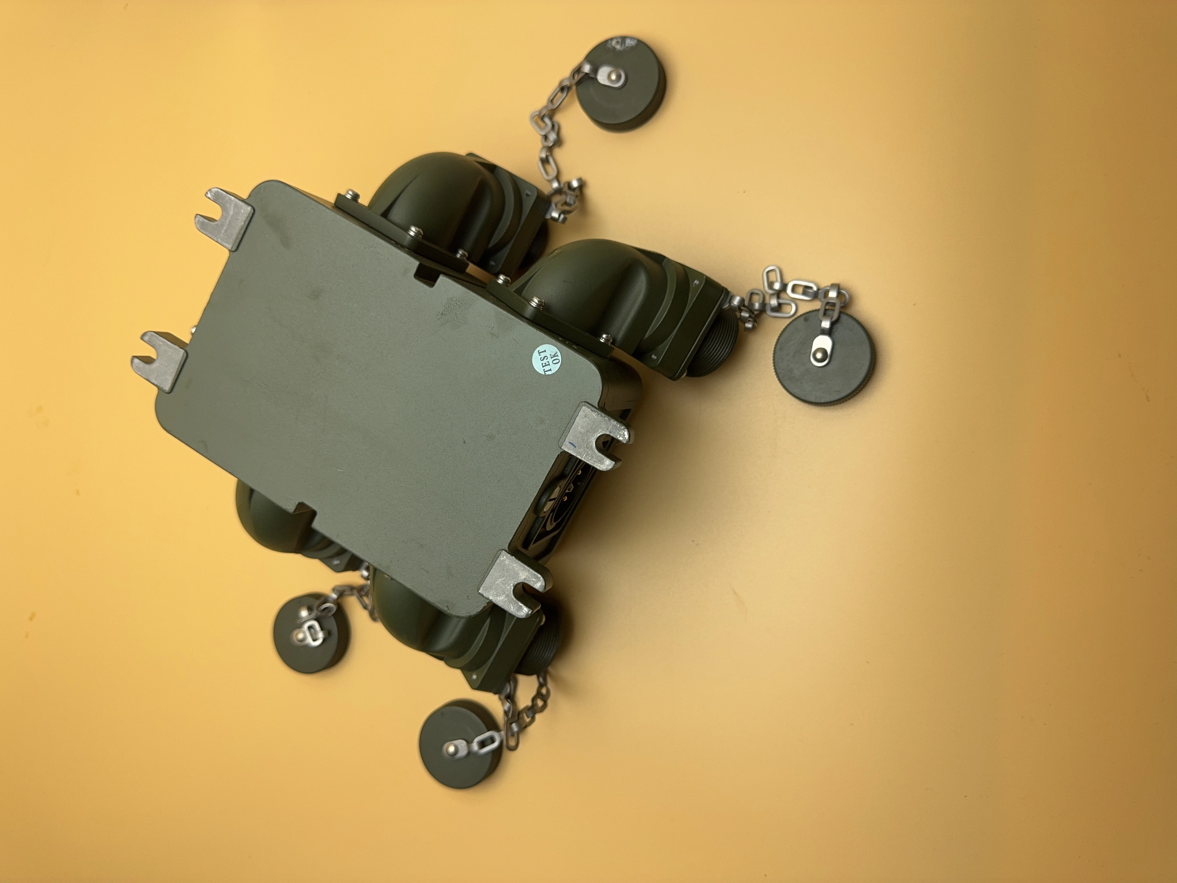 Ruggedized tactical power distributor housing assembly for armored vehicles