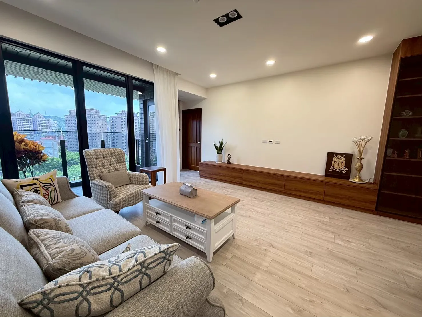 現代客廳木地板設計案例 淺色木地板搭配自然採光與系統櫃收納營造溫潤居家空間